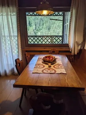 a wooden table with a bowl of fruit on it at Appartamento Duplex San Vito di Cadore in San Vito di Cadore