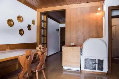 a room with a table and chairs and a fireplace at Appartamento Duplex San Vito di Cadore in San Vito di Cadore