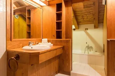 a bathroom with a sink and a bath tub at Appartamento Duplex San Vito di Cadore in San Vito di Cadore