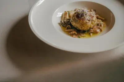 a bowl of food on a plate on a table at Zallinger Dolomites in Seiser Alm