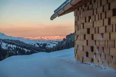 a building in the snow with a view of the mountains at Zallinger Dolomites in Seiser Alm