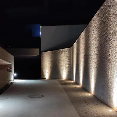 a dark hallway with lights on a wall at Nido City Studio in Brixen