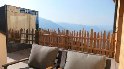 a hot tub with a view of the mountains at Noelani natürliches Waldidyll in San Genesio Atesino