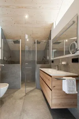 a bathroom with a glass shower and a sink at Noelani natürliches Waldidyll in San Genesio Atesino