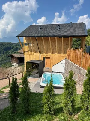 a house with a swimming pool in front of it at Noelani natürliches Waldidyll in San Genesio Atesino