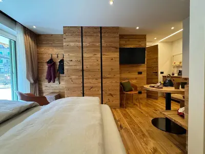 a bedroom with a bed and a desk in a room at Lisa Da Pent in Canazei