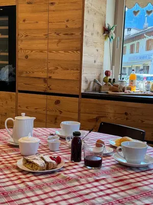 a table with a table cloth with breakfast foods on it at Lisa Da Pent in Canazei