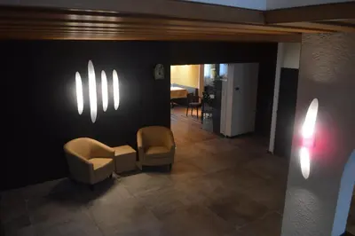 a waiting room with two chairs and lights on the wall at Hotel Weingarten in Naturno