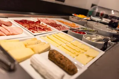 a buffet with cheese and meats and other foods at Villa Hubertus Luxuria Nova Suites - Adults friendly in Naturno