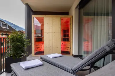 a balcony with two white towels sitting on a table at Villa Hubertus Luxuria Nova Suites - Adults friendly in Naturno