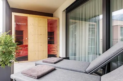 a balcony with two pillows sitting on a balcony at Villa Hubertus Luxuria Nova Suites - Adults friendly in Naturno