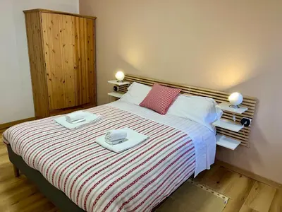 a bedroom with a bed with two towels on it at Casa ai Dossi in Bellamonte