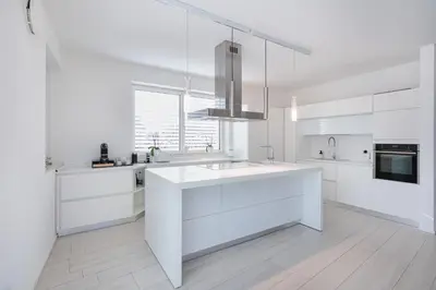 a white kitchen with a sink and a microwave at SWEETHOME TALVERA - con Garage in Bolzano