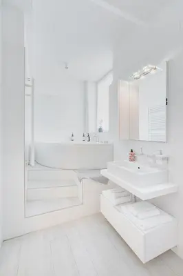 a white bathroom with a sink and a mirror at SWEETHOME TALVERA - con Garage in Bolzano