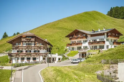 a house on the side of a hill at Hotel Daniel in Selva di Val Gardena