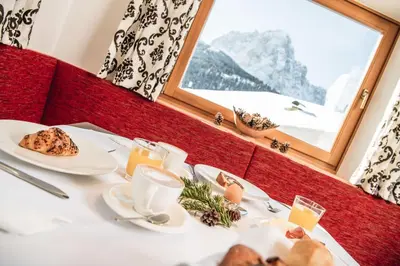 a display of different types of bread and pastries at Hotel Daniel in Selva di Val Gardena