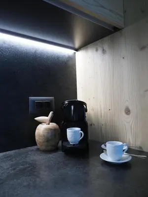 a counter with two cups and a coffee maker at Càbassa Moena in Moena