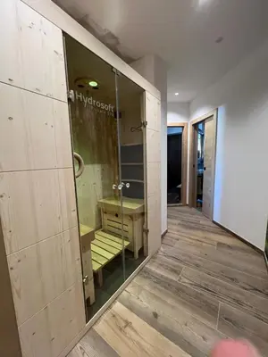 a room with a glass door with a bench in it at Càbassa Moena in Moena