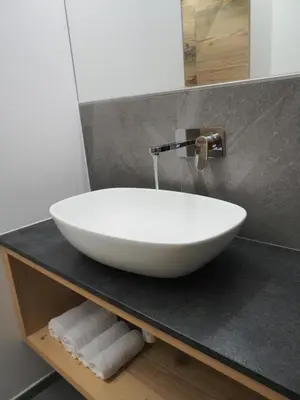 a white sink on a counter in a bathroom at Càbassa Moena in Moena