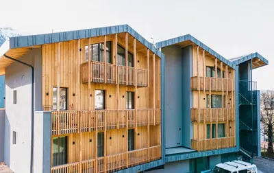 a building with two balconies on the side of it at mySHH in Vigo di Fassa