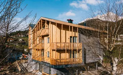 a building with a balcony on the side of it at mySHH in Vigo di Fassa