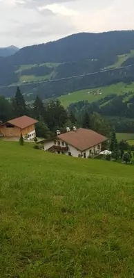 a large field of green grass with a house at Lexhof in Mareta
