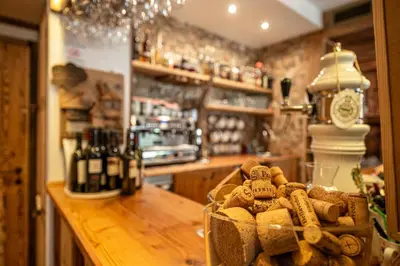 a restaurant with tables and chairs in a room at Villa Ruggero Wine Hotel in Campitello di Fassa