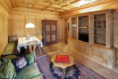 a living room with wooden walls and a table and a couch at Villa Pocol - Stayincortina in Cortina dʼAmpezzo
