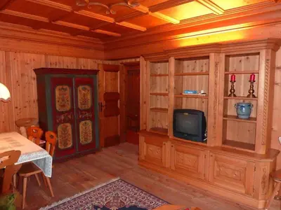 a living room with a tv and wooden walls at Villa Pocol - Stayincortina in Cortina dʼAmpezzo
