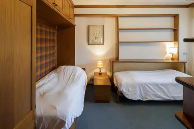 a bedroom with two beds and two lamps in it at Villa Pocol - Stayincortina in Cortina dʼAmpezzo
