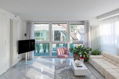 a living room with a couch and a tv at Artist House in Merano