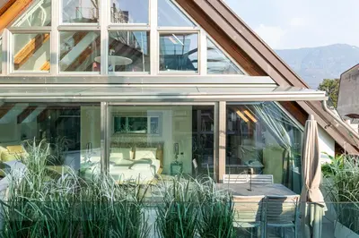 an extension of a house with sliding glass doors at Artist House in Merano