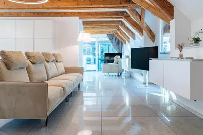 a living room with a couch and a tv at Artist House in Merano