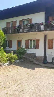a house with a balcony with flowers on it at Roda de Vael in Moena