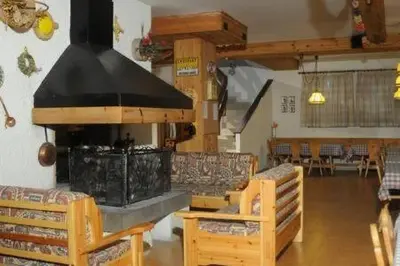 a living room with a fireplace and a couch at Casa Canazei, 2-5 pers Appartement 122 in Canazei