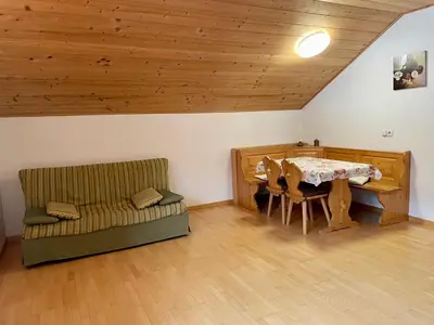 a living room with a table and a couch at Mahrhof zu Adlitzhausen in Scandole