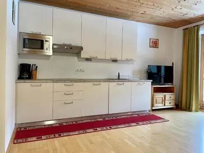 a kitchen with white cabinets and a microwave at Mahrhof zu Adlitzhausen in Scandole