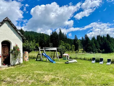 a yard with a playground and a slide at Mahrhof zu Adlitzhausen in Scandole
