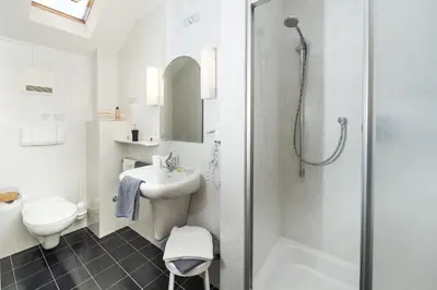 a bathroom with a shower toilet and a sink at Garni Osannahöfl in Caldaro