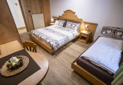 an overhead view of a living room and kitchen with a table at appartamenti dei Maerins in Pozza di Fassa