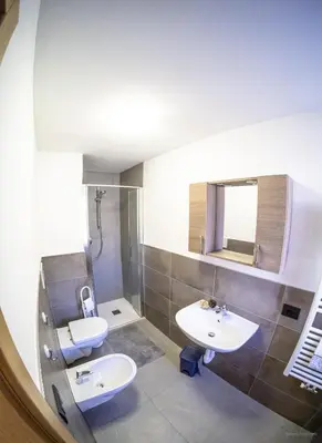 a kitchen and dining room with a table and a couch at appartamenti dei Maerins in Pozza di Fassa