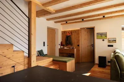 a yard with a fence and a tree at Chalet Astra, Whirlpool & Sauna in San Pancrazio dʼUltimo