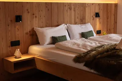 a hot tub on a deck with a view of the mountains at Chalet Astra, Whirlpool & Sauna in San Pancrazio dʼUltimo