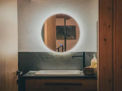a bathroom with a sink and a mirror at Chalet Astra, Whirlpool & Sauna in San Pancrazio dʼUltimo