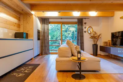 a living room with a couch and a table at The Dreaming Home Dolomiti in Canale dʼAgordo