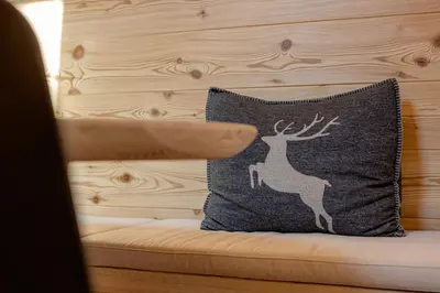 two beds in a room with white walls and wooden ceilings at The Dreaming Home Dolomiti in Canale dʼAgordo