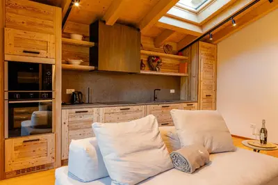 a wooden balcony with a view of the mountains at The Dreaming Home Dolomiti in Canale dʼAgordo