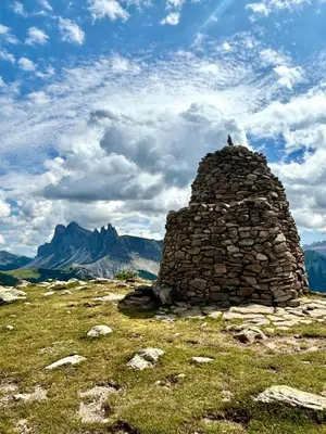 a bird sitting on top of a stone building on a mountain at Apartments Praverd nelle Dolomiti in Santa Cristina in Val Gardena