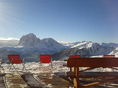 a group of chairs sitting on top of a mountain at Apartments Praverd nelle Dolomiti in Santa Cristina in Val Gardena