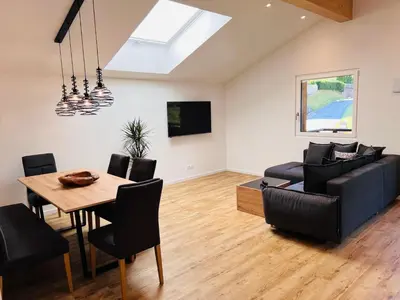 a living room with a dining table and a couch at Apartments P19 nelle Dolomiti in Ortisei